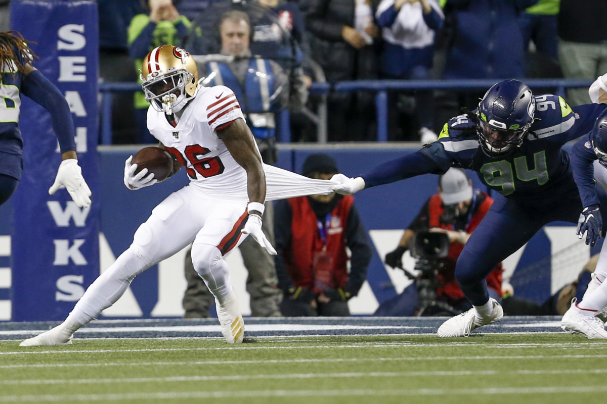 Seattle Seahawks defensive end Ezekiel Ansah (94) tackles San Francisco 49ers running back Tevin Coleman (26) during the first quarter at CenturyLink Field.
