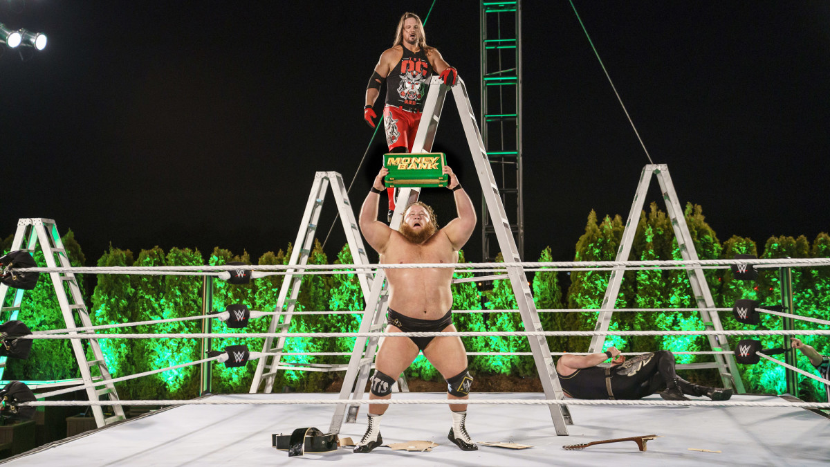 WWE's Otis holds the Money in the Bank briefcase after winning the ladder match