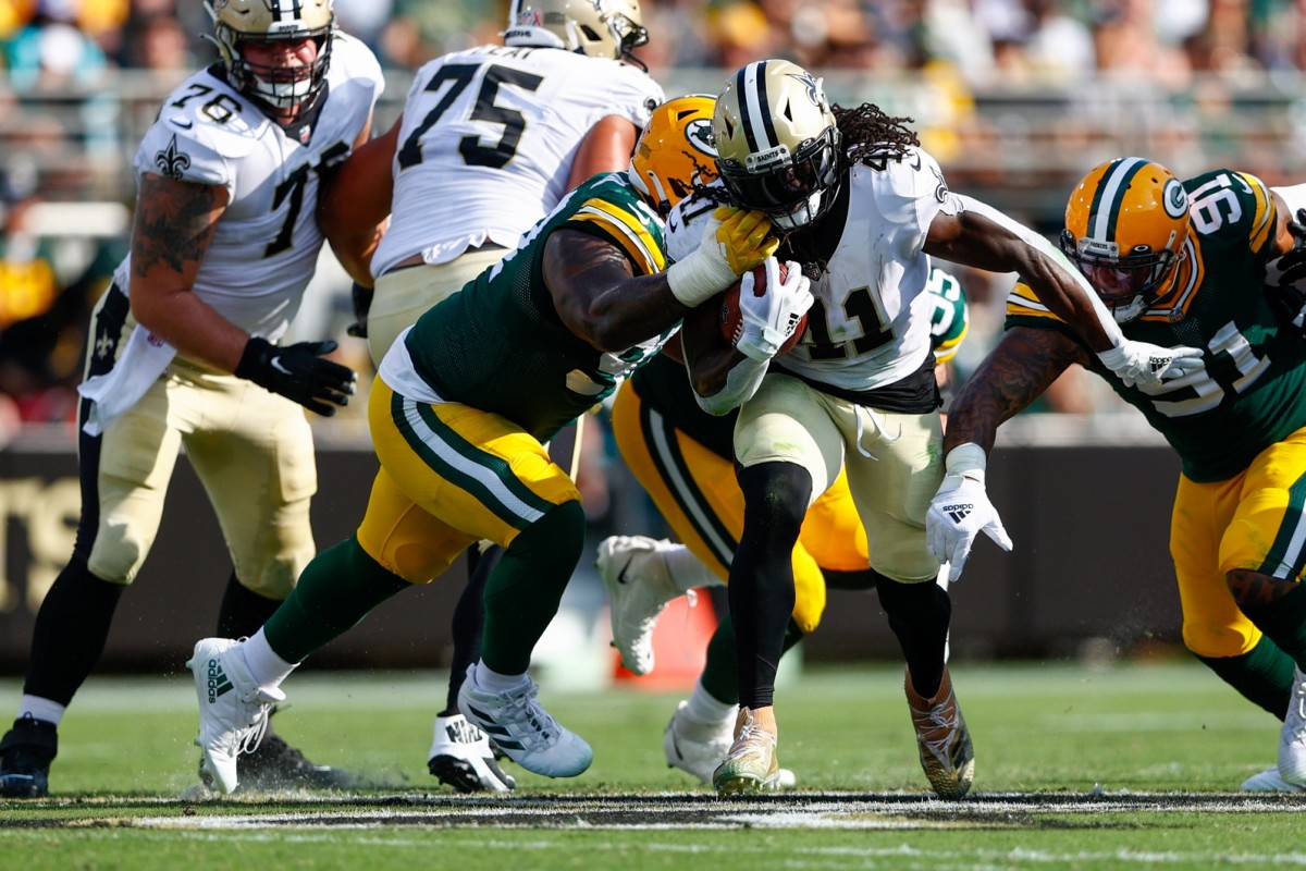 New Orleans Saints running back Alvin Kamara (41) carries the ball as Green Bay tackle Kenny Clark (97) defends. Mandatory Credit: Nathan Ray Seebeck-USA TODAY Sports