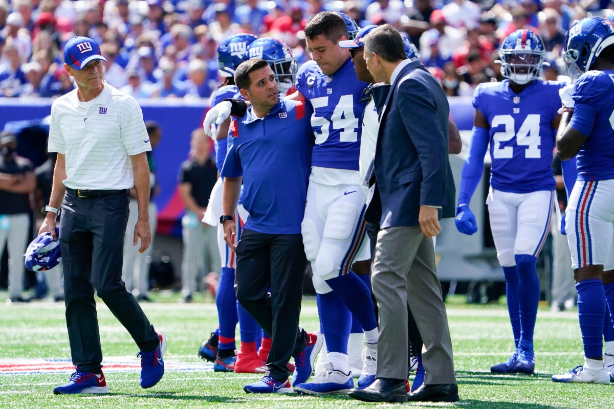 New York Giants inside linebacker Blake Martinez (54) is helped off the field in the first half at MetLife Stadium on Sunday, Sept. 26, 2021, in East Rutherford.