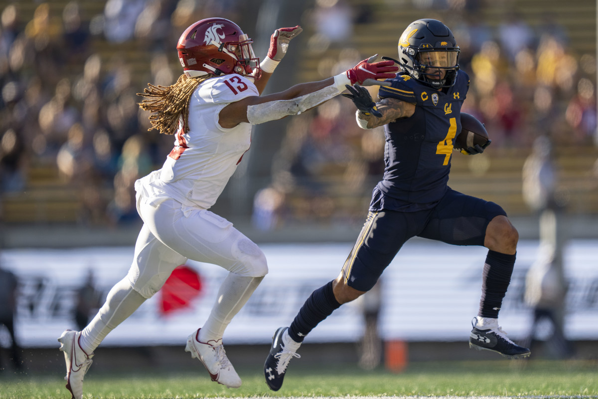 California Golden Bears wide receiver Nikko Remigio (4) runs against Washington State Cougars linebacker Jahad Woods (13) during the third quarter at FTX Field at California Memorial Stadium.