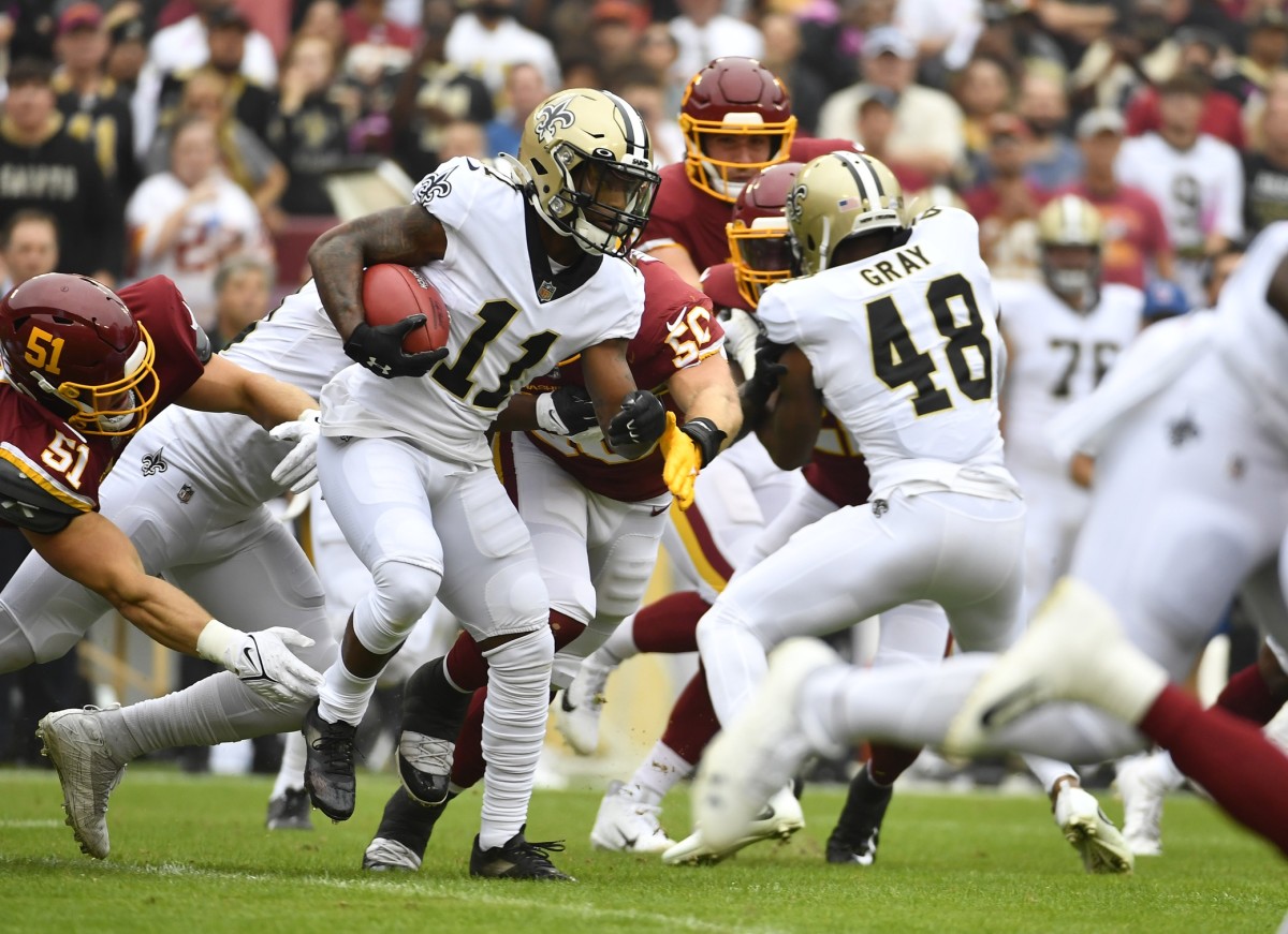New Orleans Saints wide receiver Deonte Harris (11) returns a kick against Washington. Mandatory Credit: Brad Mills-USA TODAY