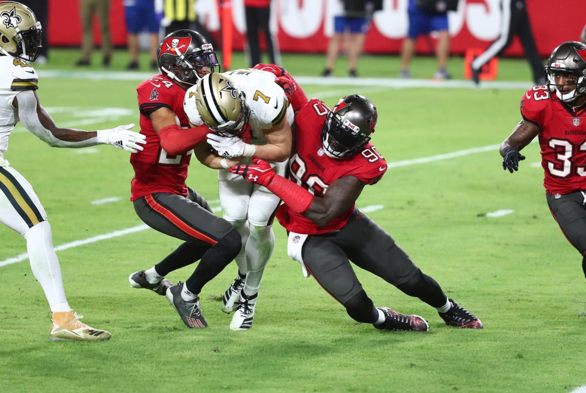 Tampa Bay Buccaneers cornerback Carlton Davis (24) and linebacker Jason Pierre-Paul (90) tackle Saints quarterback Taysom Hill (7). Mandatory Credit: Kim Klement-USA TODAY Sports