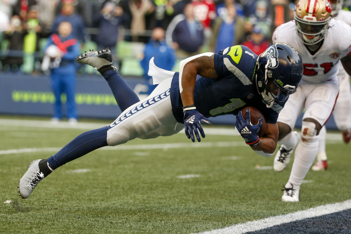 Seattle Seahawks wide receiver D'Wayne Eskridge (1) scores a touchdown reception against the San Francisco 49ers during the second quarter at Lumen Field.