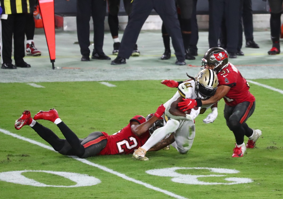 New Orleans Saints Alvin Kamara (41) runs with the ball as Tampa Bay Buccaneers safety Antoine Winfield Jr. (31) defends. Mandatory Credit: Kim Klement-USA TODAY Sports