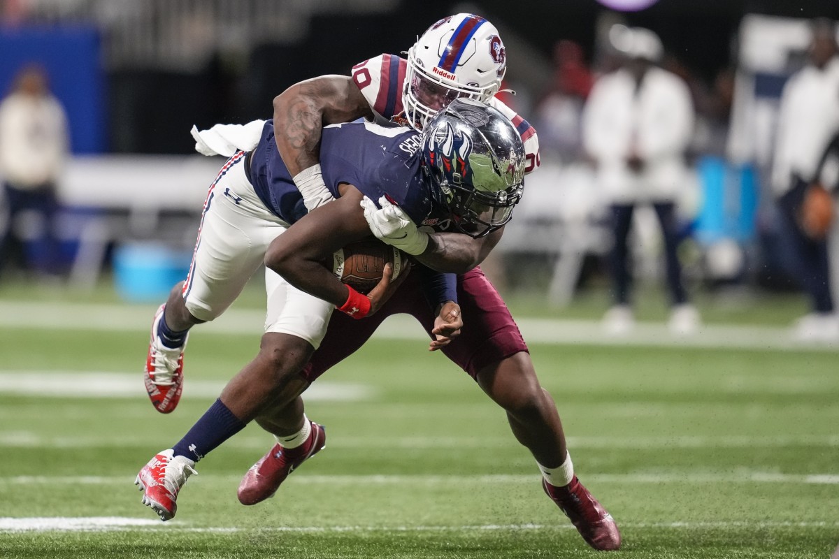 South Carolina State Bulldogs linebacker Aaron Smith (29) tackles Jackson State Tigers quarterback Shedeur Sanders (2)