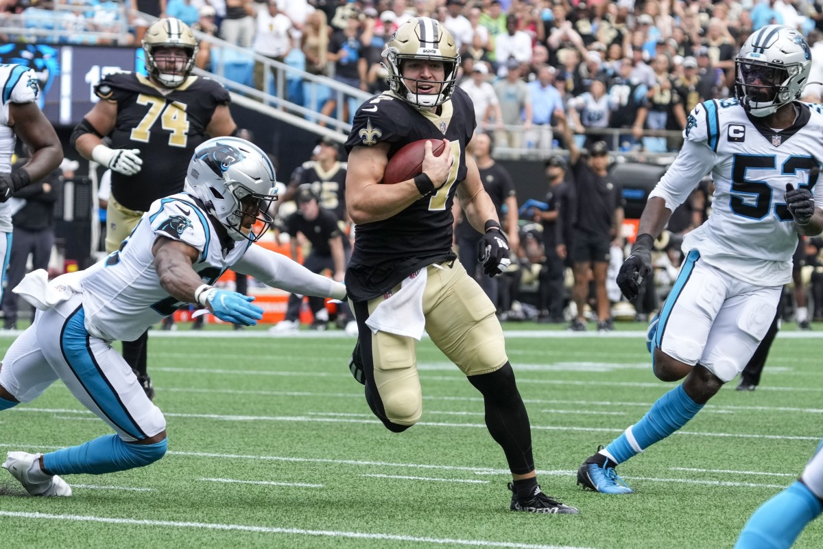 New Orleans Saints Taysom Hill (7) runs past Panthers safety Jeremy Chinn (21). Mandatory Credit: Jim Dedmon-USA TODAY Sports