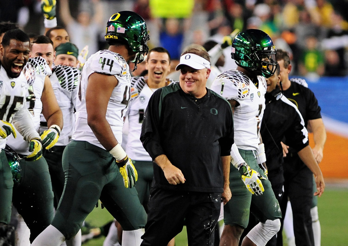 Chip Kelly celebrates a Fiesta Bowl victory with defensive lineman DeForest Buckner (44) to close out the 2012 season.