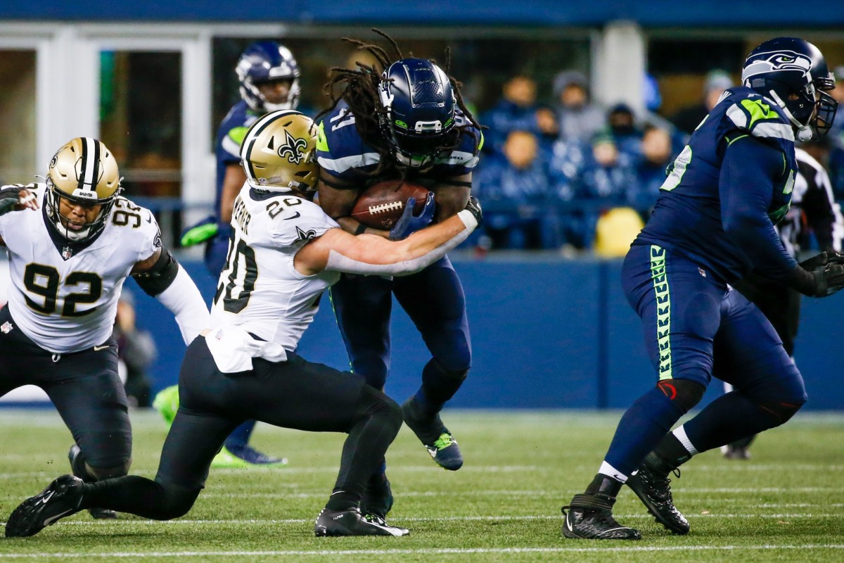 New Orleans Saints linebacker Pete Werner (20) tackles Seattle Seahawks running back Alex Collins (41). Mandatory Credit: Joe Nicholson-USA TODAY Sports