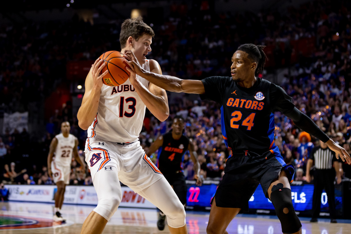 Feb 19, 2022; Gainesville, Florida, USA; Florida Gators guard Phlandrous Fleming Jr. (24) plays defense on Auburn Tigers forward Walker Kessler (13) during the first half at Billy Donovan Court at Exactech Arena. Mandatory Credit: Matt Pendleton-USA TODAY Sports