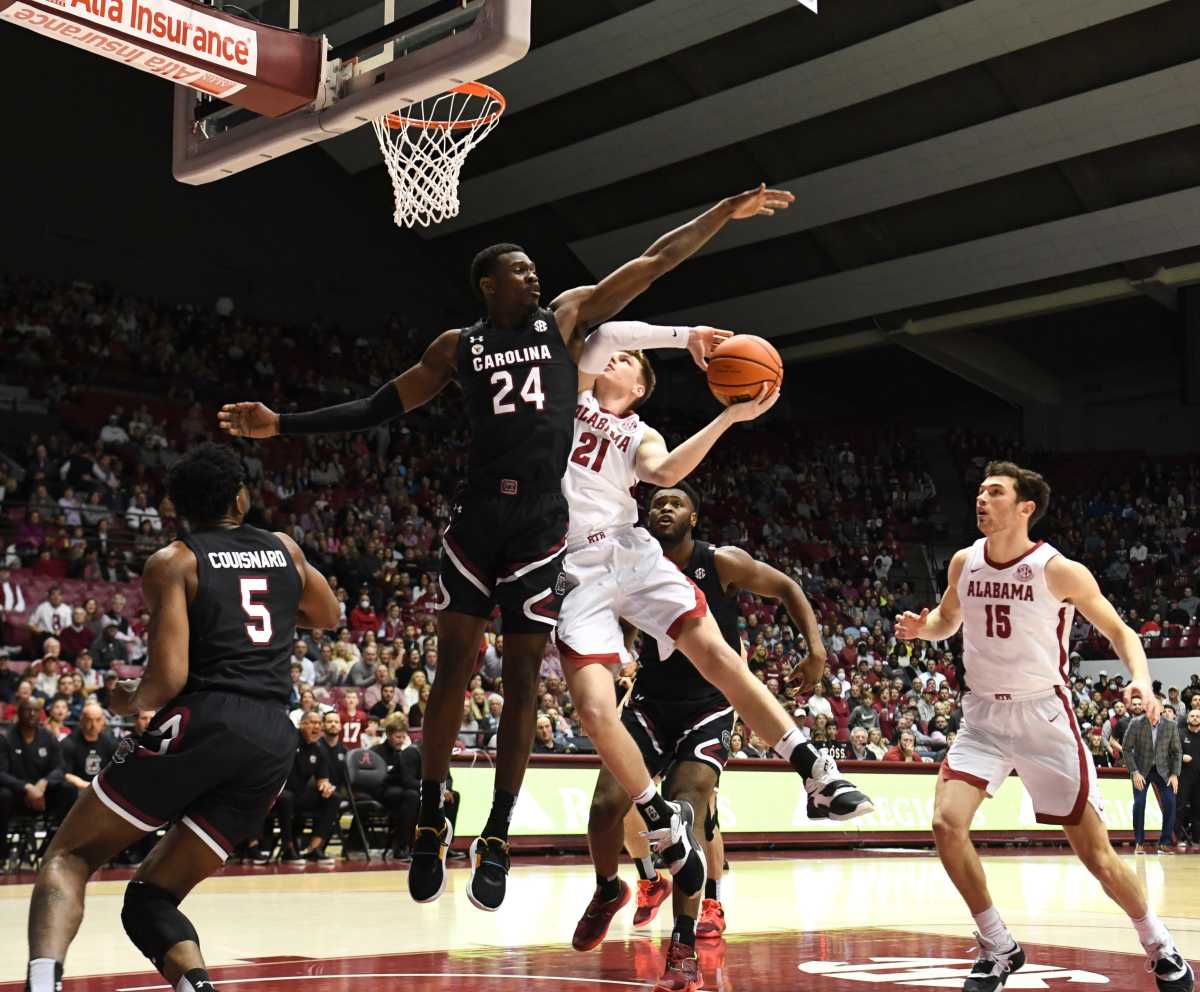 South Carolina forward Keyshawn Bryant (24) defends a shot in the lane by Alabama guard Britton Johnson (21) Saturday, Feb. 26, 2022, at Coleman Coliseum in Tuscaloosa, Alabama. Alabama Vs South Carolina