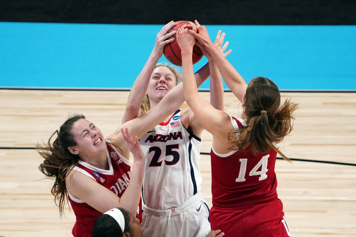 Mackenzie Holmes and Ali Patberg go for an Arizona player's ball.