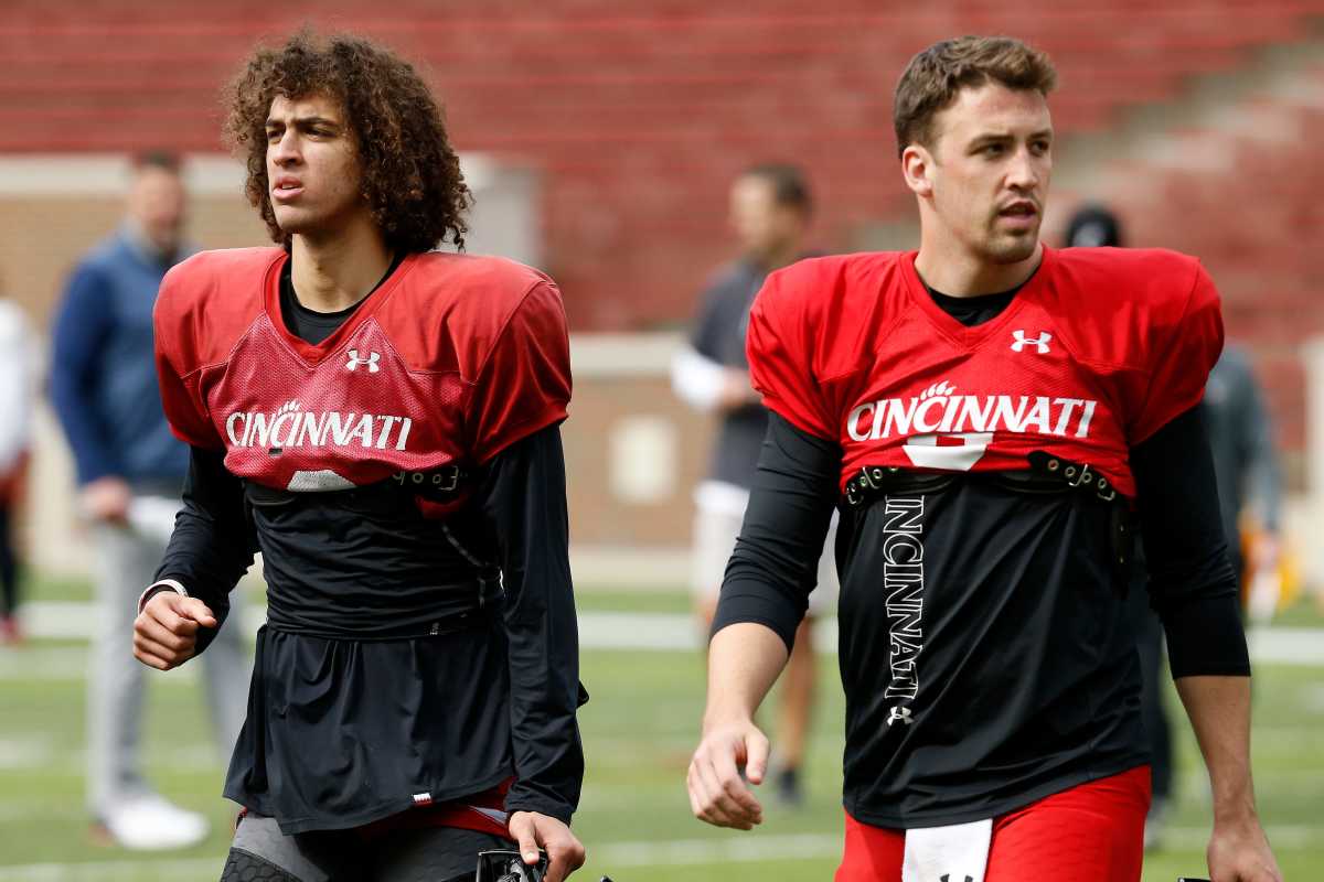 Cincinnati Bearcats quarterbacks Evan Prater (3) and Ben Bryant (6) finish a session during a spring practice at Nippert Stadium in Cincinnati on Thursday, March 24, 2022. Cincinnati Bearcats Spring Practice