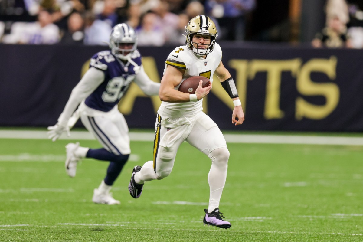 New Orleans Saints quarterback Taysom Hill (7) runs past against Dallas Cowboys defensive end Tarell Basham (93). Mandatory Credit: Stephen Lew-USA TODAY Sports