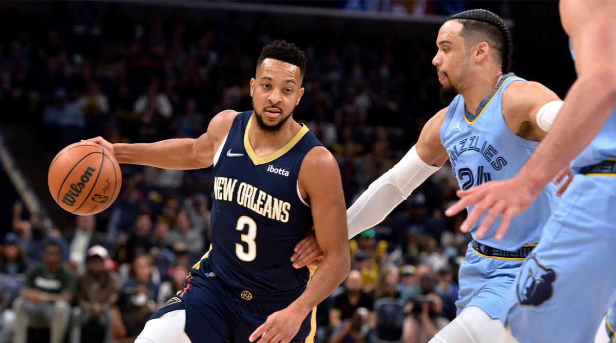 New Orleans Pelicans guard CJ McCollum (3) drives on Memphis Grizzlies forward Dillon Brooks (24) during the first half of an NBA basketball game Saturday, April 9, 2022, in Memphis, Tenn.