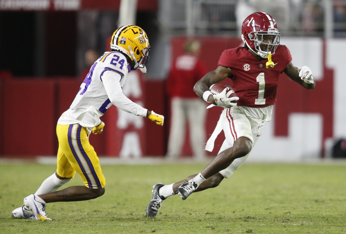 Alabama receiver Jameson Williams (1) runs past LSU defensive back Darren Evans (24). Mandatory Credit: Gary Cosby Jr.-USA TODAY Sports