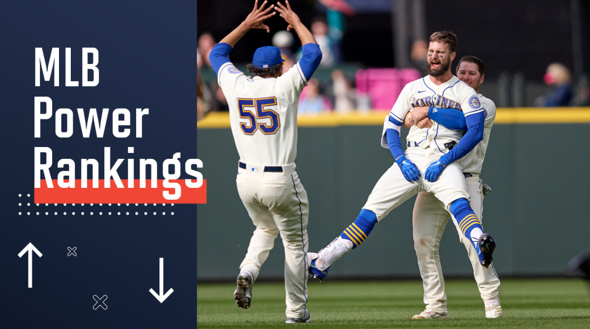 Seattle Mariners’ Jesse Winker, front right, is lifted by Ty France as he celebrates a win over Kansas City Royals in 12 innings of a baseball game, Sunday, April 24, 2022, in Seattle.