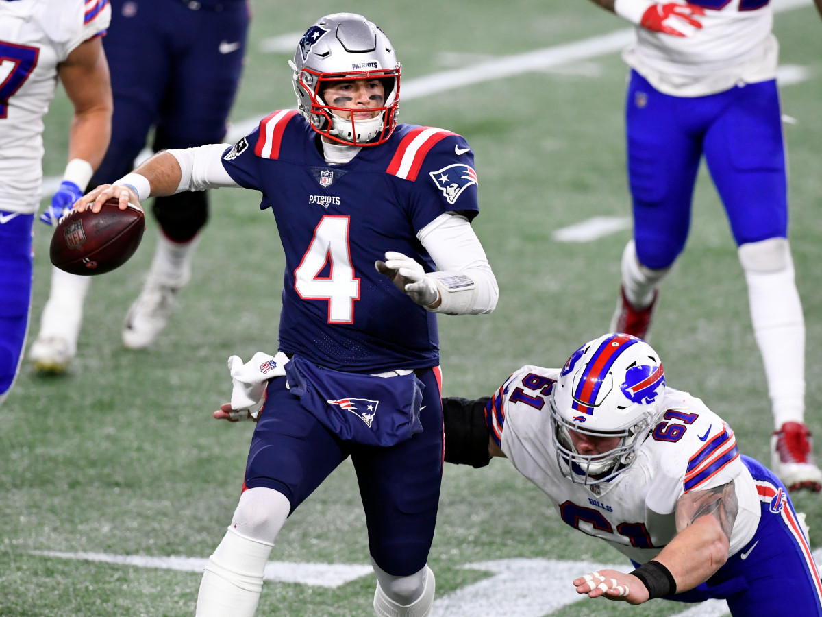 Dec 28, 2020; Foxborough, Massachusetts, USA; New England Patriots quarterback Jarrett Stidham (4) looks to pass under pressure from Buffalo Bills defensive tackle Justin Zimmer (61) during the second half at Gillette Stadium. Mandatory Credit: Brian Fluharty-USA TODAY Sports