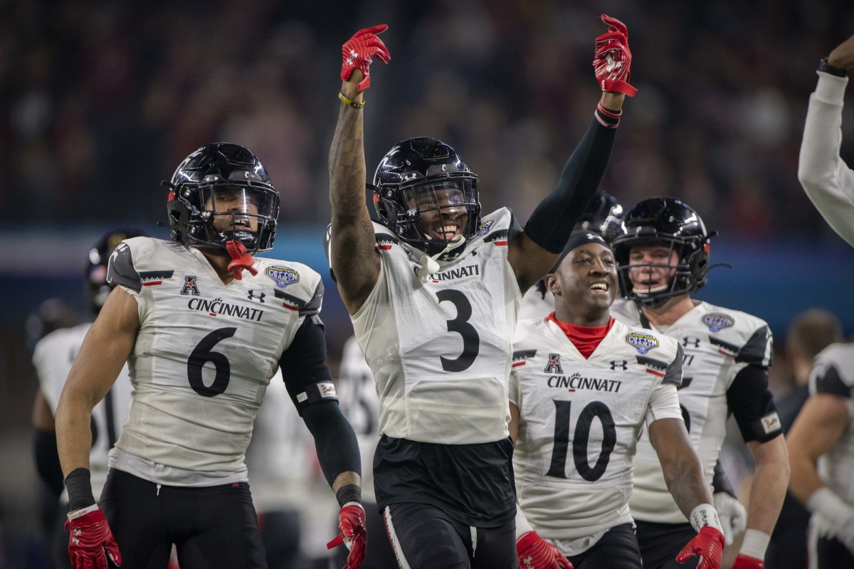 Dec 31, 2021; Arlington, Texas, USA; Cincinnati Bearcats safety Bryan Cook (6) and safety Bryan Cook (6) and safety Bryon Threats (10) celebrates making an interception against the Alabama Crimson Tide during the third quarter during the 2021 Cotton Bowl college football CFP national semifinal game at AT&T Stadium. Mandatory Credit: Jerome Miron-USA TODAY Sports