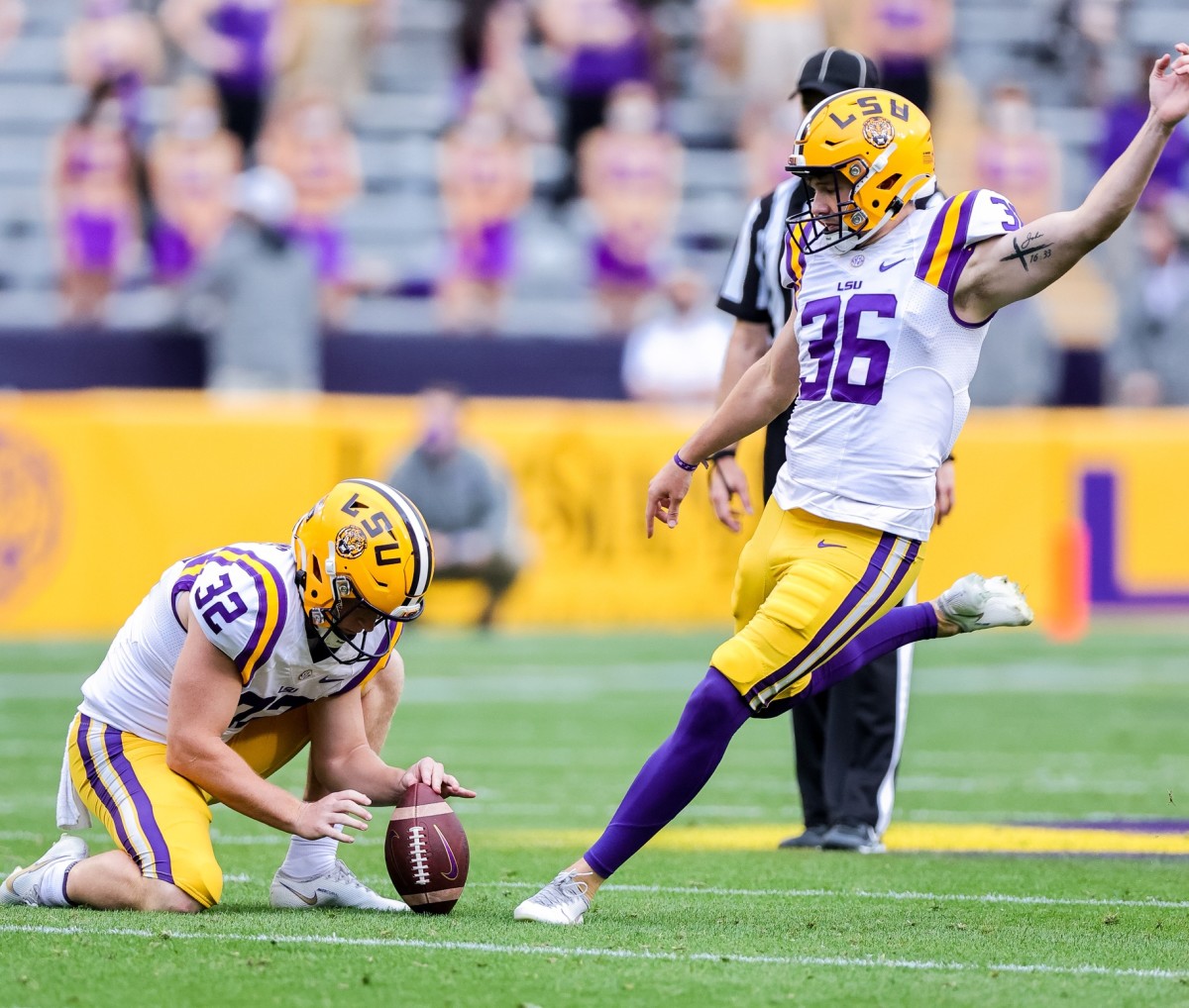 Apr 17, 2021; Baton Rouge, Louisiana, USA; LSU Tigers place kicker Cade York (36) kicks a field goal with place kicker Avery Atkins (32) holding the ball during the first half of the annual Purple and White spring game at Tiger Stadium. Mandatory Credit: Stephen Lew-USA TODAY Sports