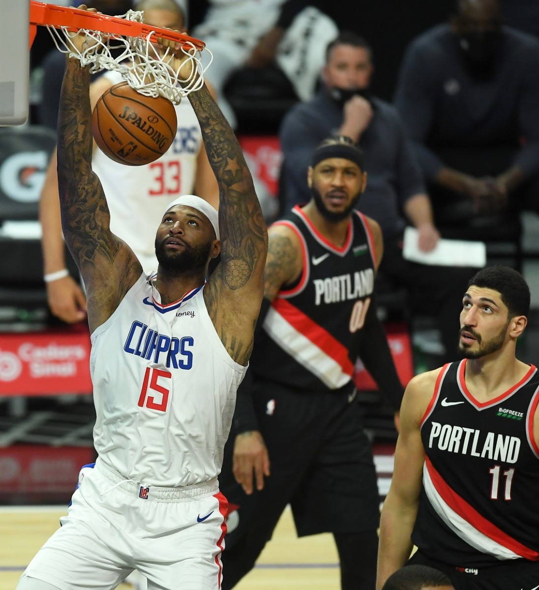 Apr 6, 2021; Los Angeles, California, USA; Portland Trail Blazers forward Carmelo Anthony (00) and center Enes Kanter (11) look on as Los Angeles Clippers center DeMarcus Cousins (15) goes up for a dunk in the first half of the game at Staples Center. Mandatory Credit: Jayne Kamin-Oncea-USA TODAY Sports