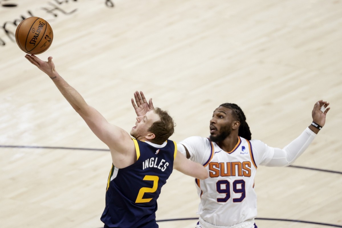 Joe Ingles (2) shoots a layup over Jae Crowder (99) and the Phoenix Suns
