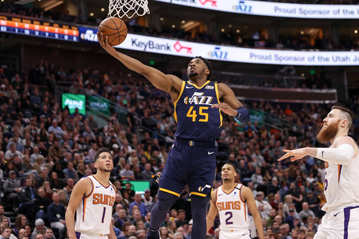 Donovan Mitchell (45) scores over Devin Booker (1) and the Phoenix Suns