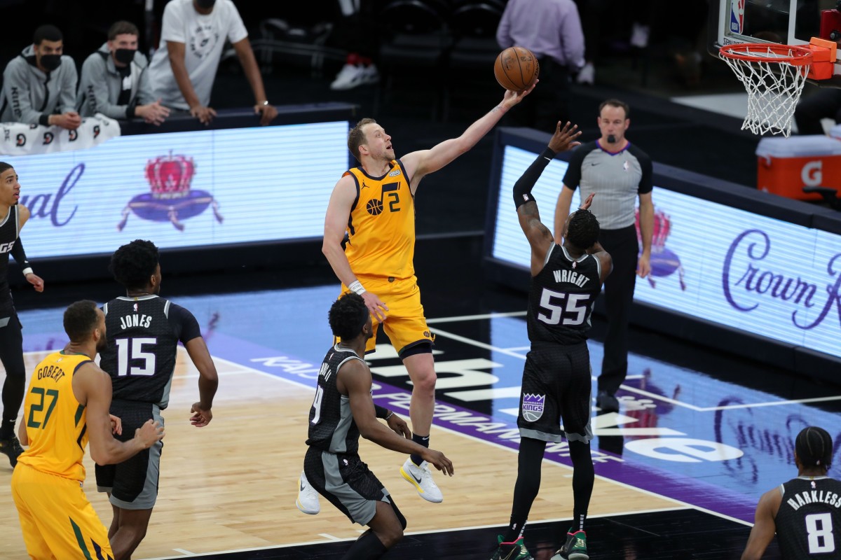 Joe Ingles (2) scores over Delon Wright (55) and the Sacramento Kings on Wednesday night