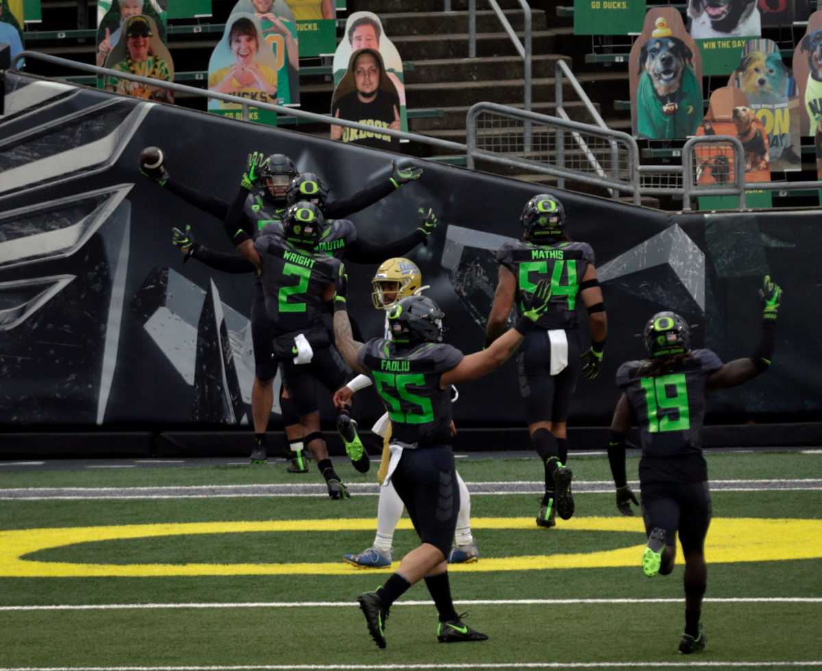 Jordan Happle celebrates a pick-six with teammates as time expires against the UCLA Bruins.
