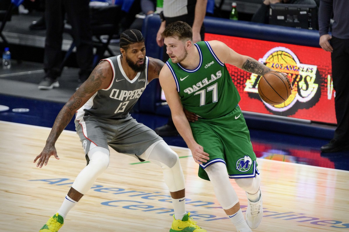 Mar 17, 2021; Dallas, Texas, USA; LA Clippers guard Paul George (13) and Dallas Mavericks guard Luka Doncic (77) in action during the game between the Dallas Mavericks and the LA Clippers at the American Airlines Center. Mandatory Credit: Jerome Miron-USA TODAY Sports