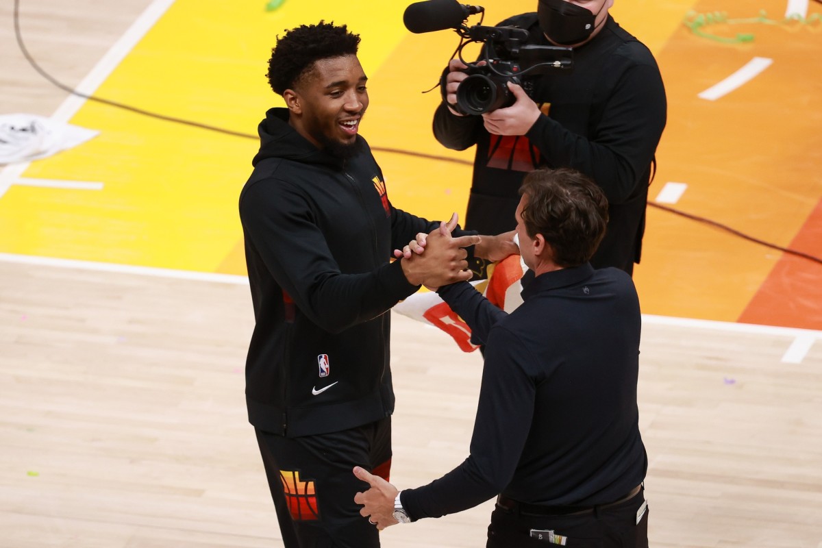 Donovan Mitchell (left) celebrates a first round win with Jazz Head Coach Quin Snyder (right)