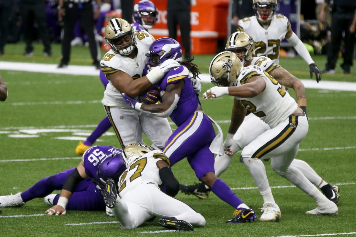 Vikings running back Dalvin Cook (33) is tackled by New Orleans defensive tackle Shy Tuttle (99) and safety Malcolm Jenkins (27). Mandatory Credit: Chuck Cook-USA TODAY Sports