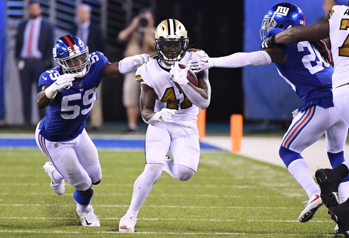 New Orleans Saints running back Alvin Kamara (41) carries between Giants linebacker Lorenzo Carter (59) and cornerback Janoris Jenkins (20). Mandatory Credit: Robert Deutsch-USA TODAY 