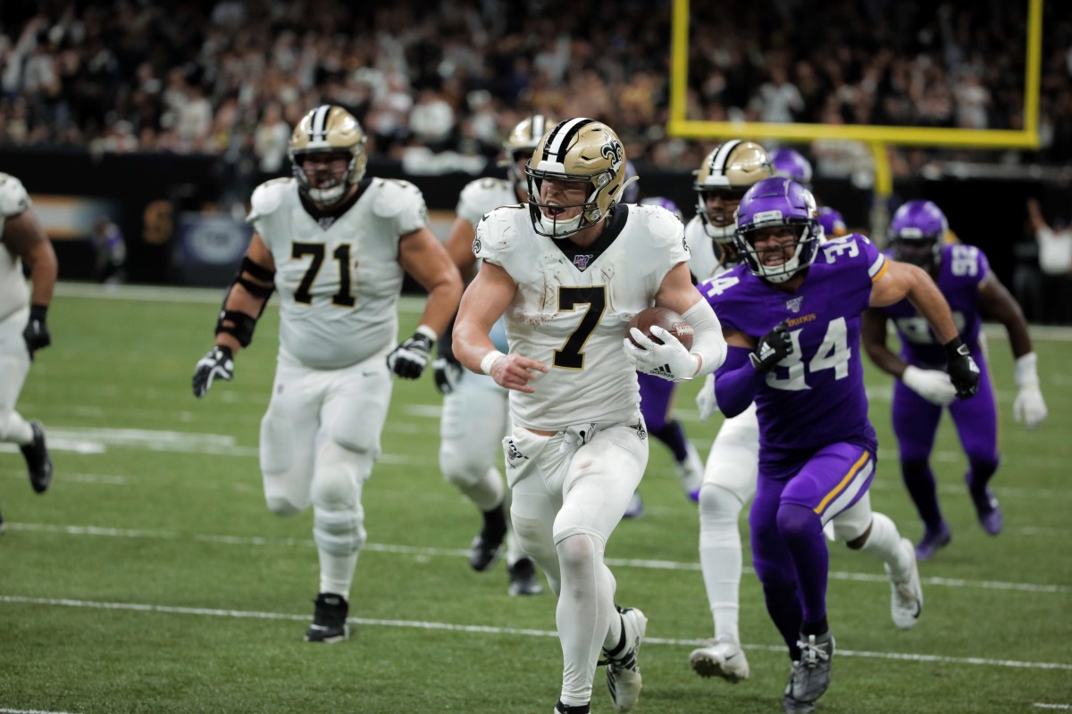New Orleans Saints player Taysom Hill (7) runs past Minnesota safety Andrew Sendejo (34). Mandatory Credit: Derick Hingle-USA TODAY Sports