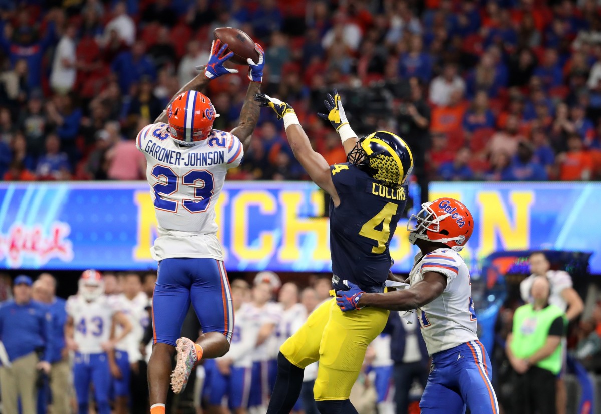 Florida Gators defensive back Chauncey Gardner-Johnson (23) intercepts a pass for Michigan Wolverines receiver Nico Collins (4). Mandatory Credit: Jason Getz-USA TODAY 