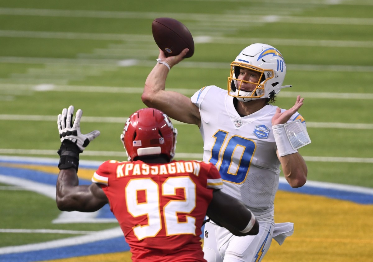 Chargers quarterback Justin Herbert (10) throws a pass against Kansas City defensive end Tanoh Kpassagnon (92). Mandatory Credit: Robert Hanashiro-USA TODAY