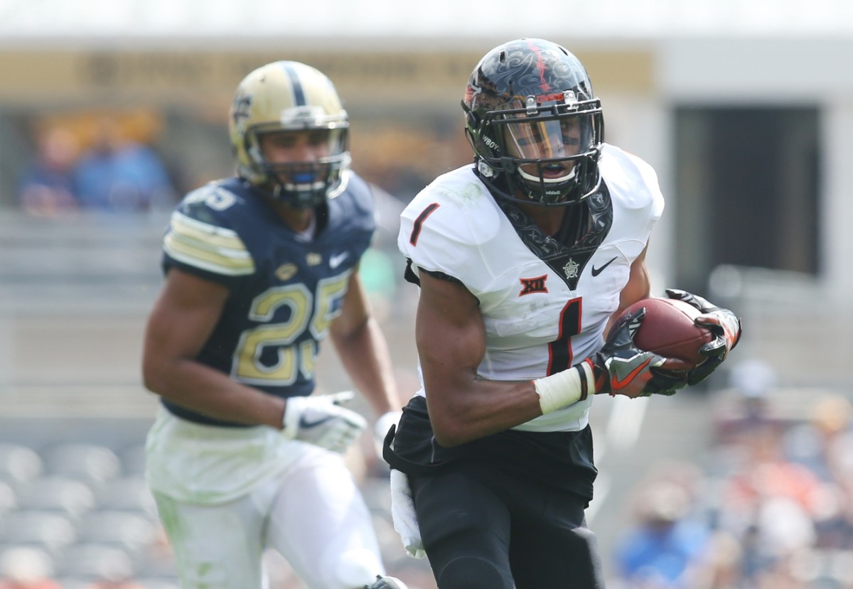 Oklahoma State wide receiver Jalen McCleskey (1) runs after a catch against the Pitt Panthers. Mandatory Credit: Charles LeClaire-USA TODAY 