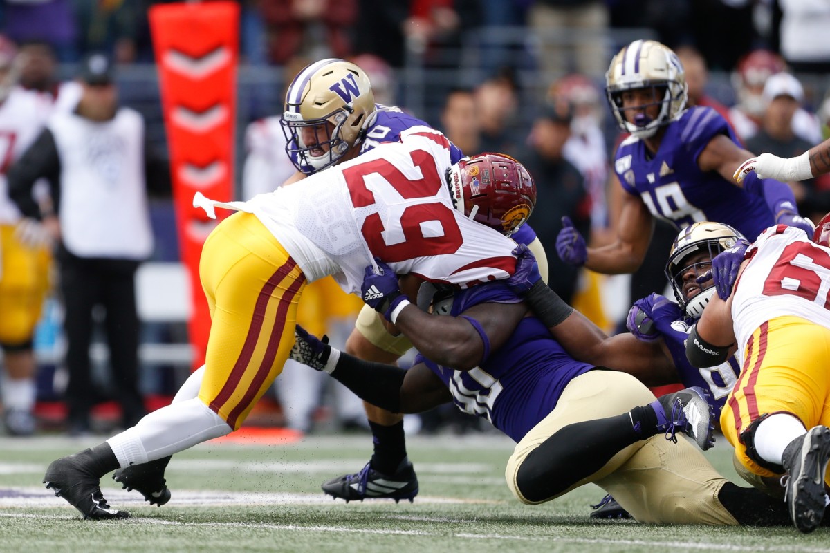 Washington Huskies linebacker Kyler Manu (30), defensive lineman Josiah Bronson (90) combine to stop USC running back Vavae Malepeai (29). Mandatory Credit: Jennifer Buchanan-USA TODAY