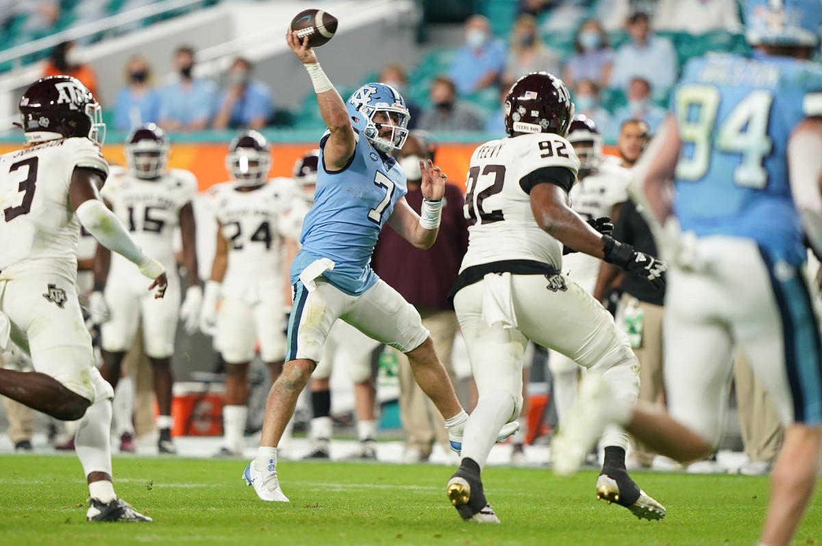Jan 2, 2021; Miami Gardens, FL, USA; North Carolina Tar Heels quarterback Sam Howell (7) gets off a pass against the Texas A&M Aggies during the second half at Hard Rock Stadium.