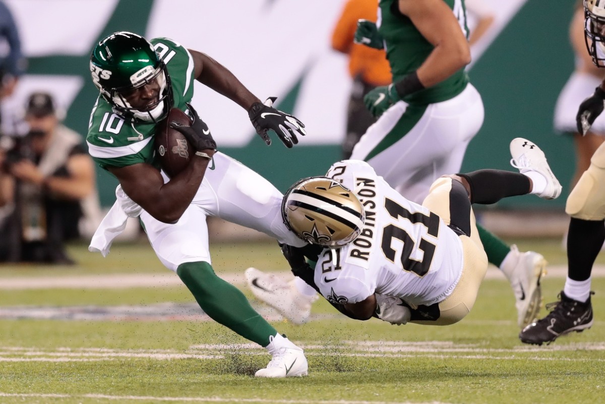 New York Jets receiver Deonte Thompson (10) is tackled by New Orleans Saints defensive back Patrick Robinson (21). Mandatory Credit: Vincent Carchietta-USA TODAY