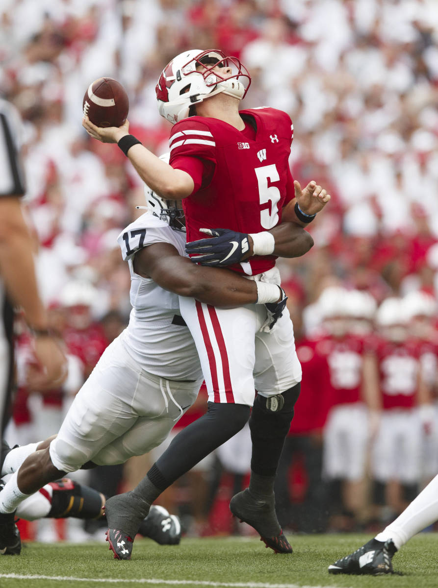 Penn State's Arnold Ebiketie hits Wisconsin quarterback Graham Mertz (Jeff Hanisch/USA Today Sports)