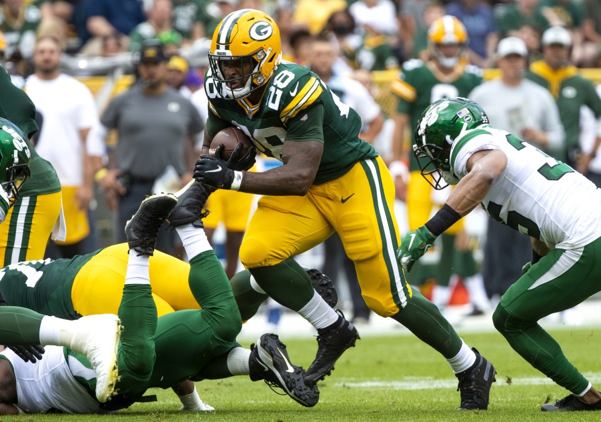 Green Bay Packers running back AJ Dillon (28) runs the ball against the New York Jets during a preseason game. Mandatory Credit: Samantha Madar/USA TODAY NETWORK-Wisconsin via USA TODAY NETWORK