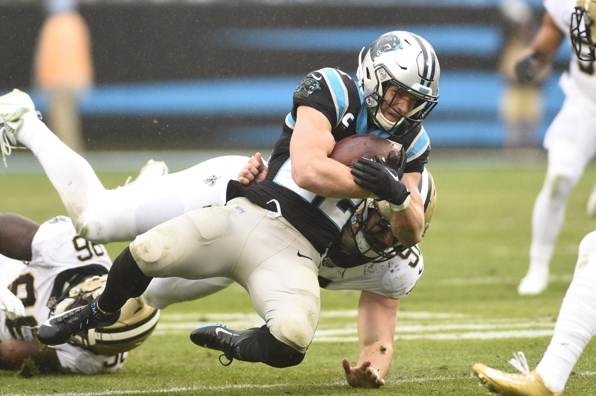 Carolina Panthers running back Christian McCaffrey (22) is tacked by New Orleans Saints defensive ends Carl Granderson (96) and Trey Hendrickson (91). Mandatory Credit: Bob Donnan-USA TODAY Sports