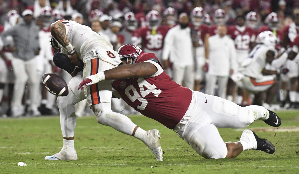 Auburn Tigers quarterback Robby Ashford (9) fumbles as he is hit by Alabama Crimson Tide defensive lineman DJ Dale (94) at Bryant-Denny Stadium. Alabama won 49-27.