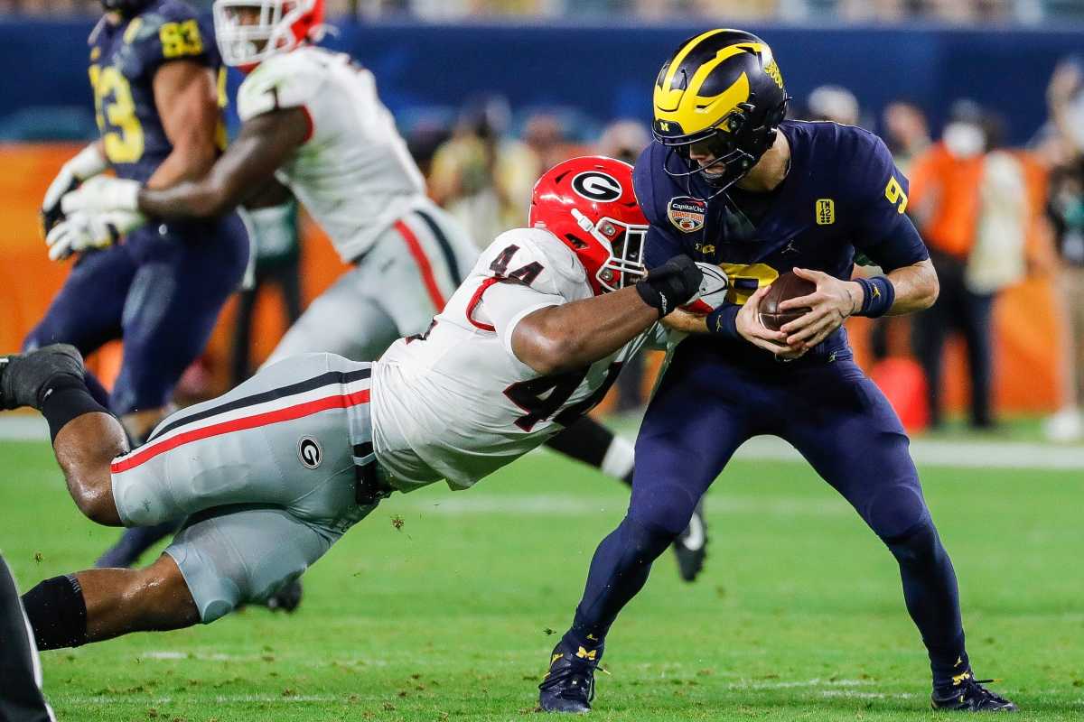 Michigan quarterback J.J. McCarthy (9) is tackled by Georgia defensive lineman Travon Walker (44) during the second half of the Orange Bowl