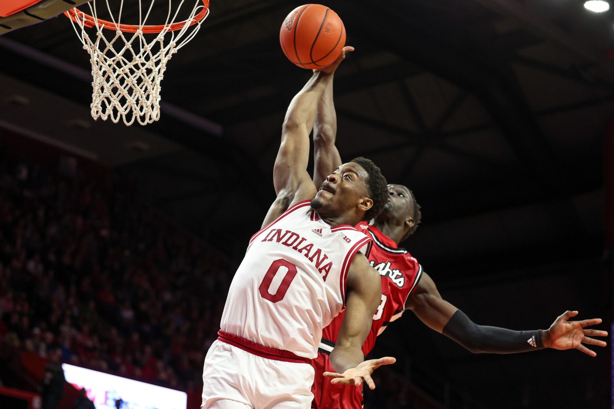 Indiana Hoosiers guard Xavier Johnson (0) drives to the basket drives to the basket as Rutgers Scarlet Knights forward Mawot Mag (3) defends during the first half at Jersey Mike's Arena.