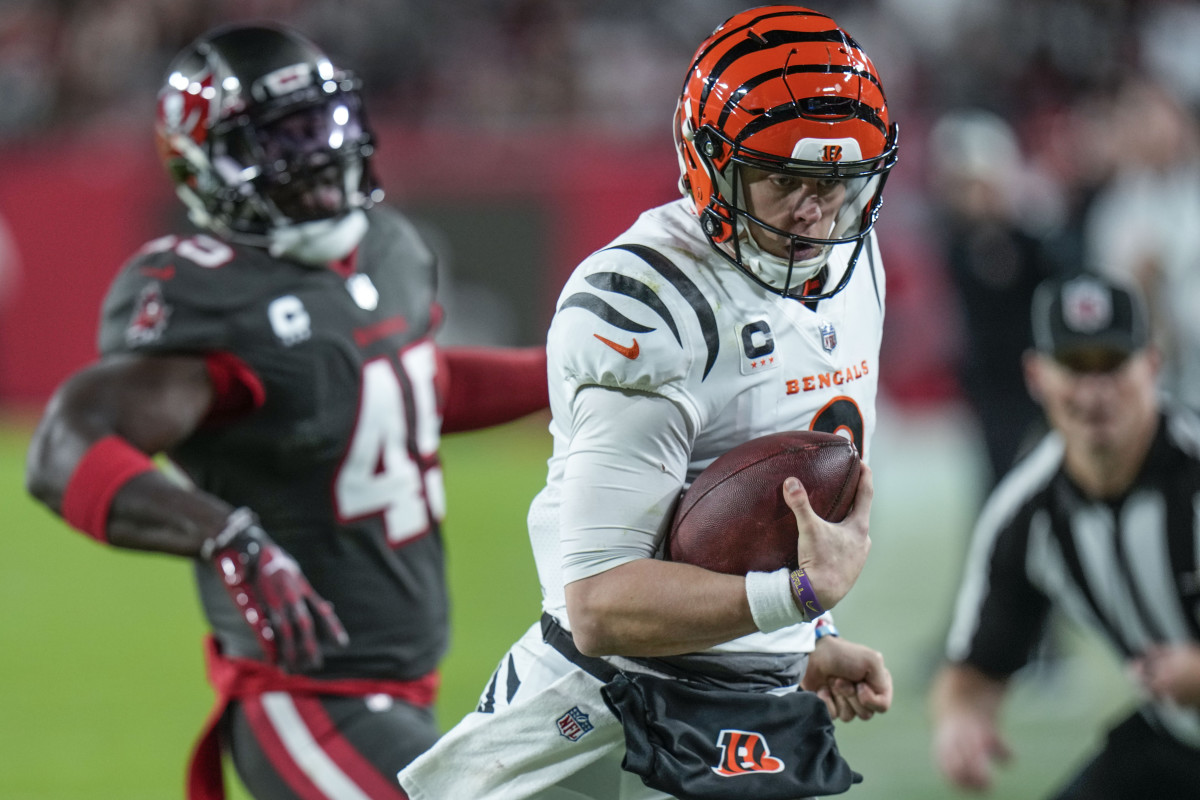 Cincinnati Bengals quarterback Joe Burrow (9) runs past Tampa Bay Buccaneers linebacker Devin White (45) during the second half of an NFL football game, Sunday, Dec. 18, 2022, in Tampa, Fla.