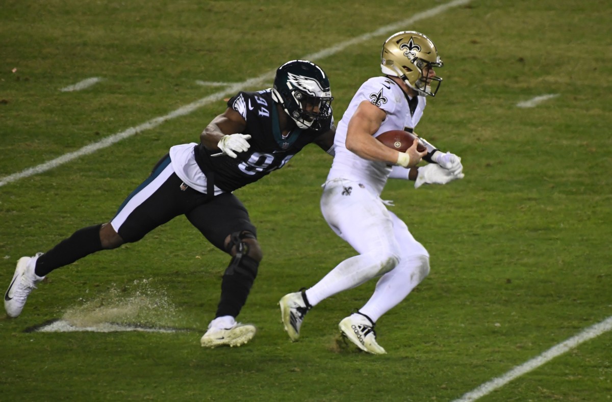 Dec 13, 2020; Taysom Hill (7) is chased by Philadelphia Eagles defensive end Josh Sweat (94). Mandatory Credit: James Lang-USA TODAY Sports