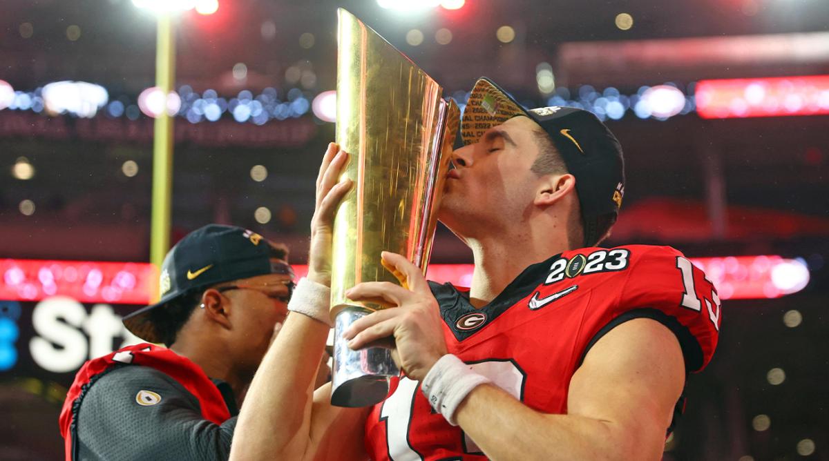 Jan 9, 2023; Inglewood, CA, USA; Georgia Bulldogs quarterback Stetson Bennett (13) kisses the trophy after winning the CFP national championship game against the TCU Horned Frogsat SoFi Stadium.