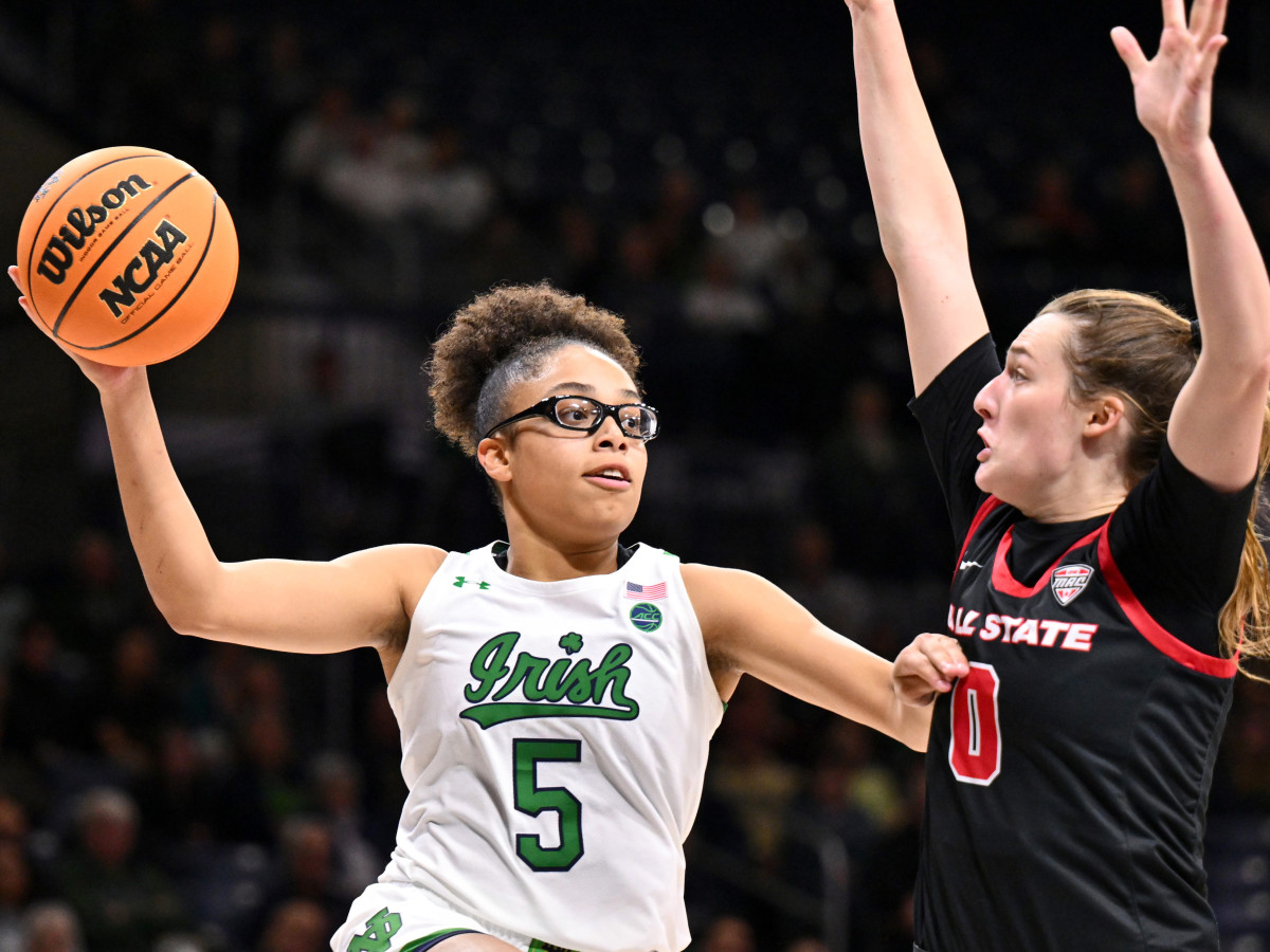 Notre Dame guard Olivia Miles passes the ball as Ball State Cardinals player Ally Becki defends.